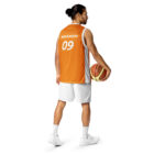 Back side view of a Male wearing the Bitcoin Basketball Jersey with cargo pants. The Jersey features "Nakamoto" across the top and the year 09, the year bitcoin was created in 2009. The lettering is in bitcoin font Ubuntu bold italic.