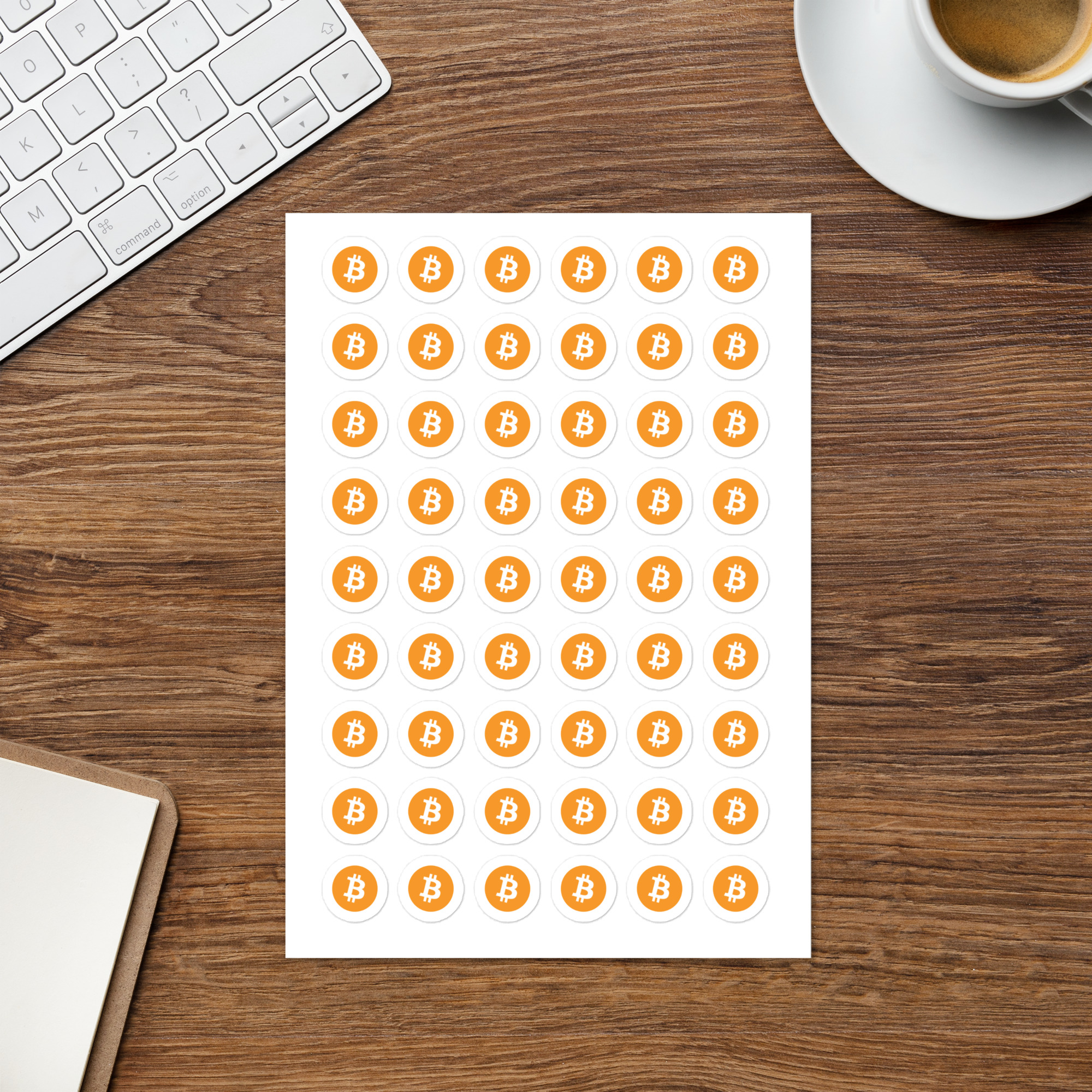 Bitcoin Stickers Sheet on a desk with a keyboard a coffee cup. Featuring 54 stickers for only $6.